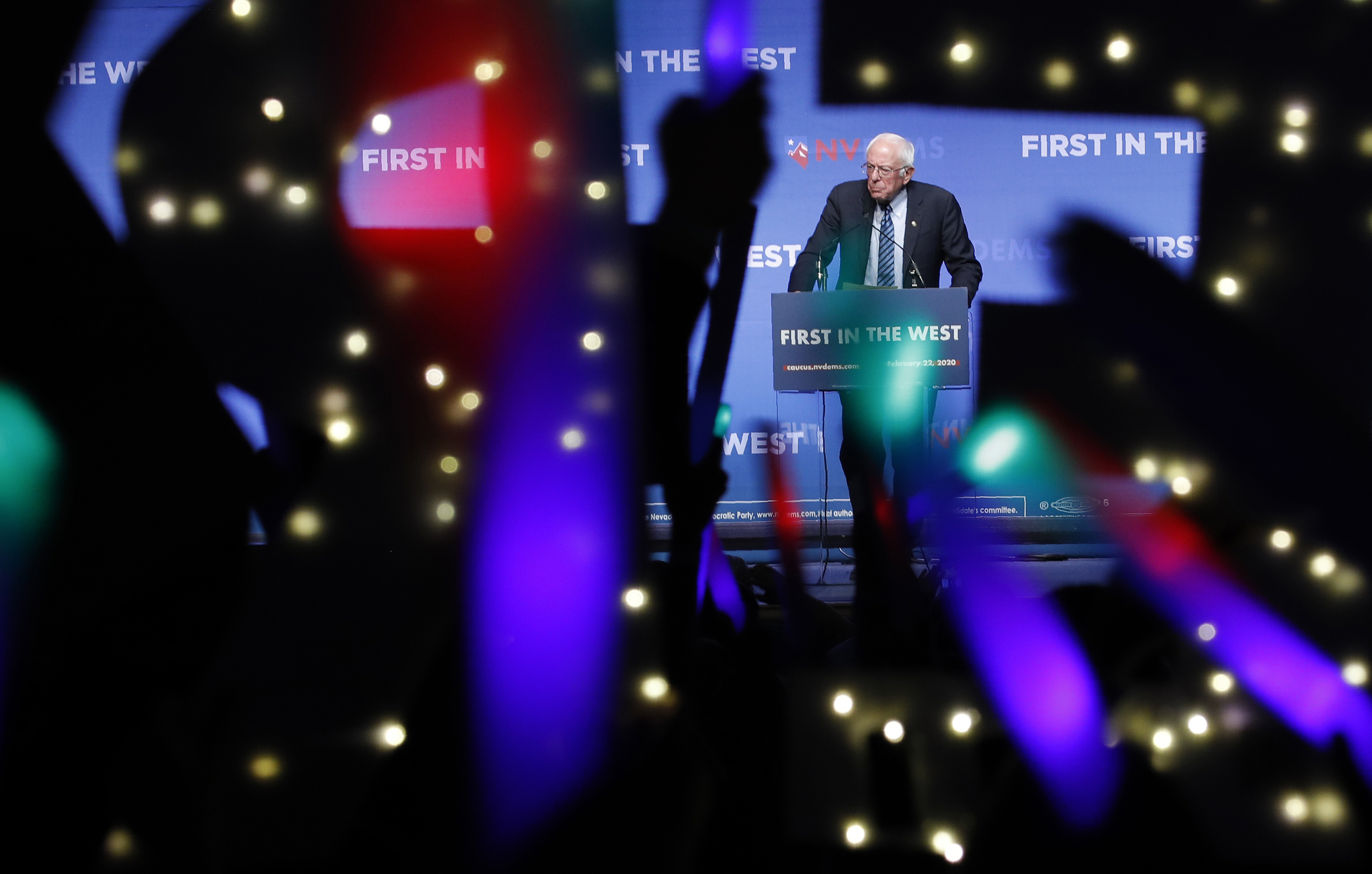 (AP Photo/John Locher) In this Sunday, Nov. 17, 2019, file photo, Democratic presidential candidate Sen. Bernie Sanders, I-Vt., speaks as supporters wave lighted signs during a fundraiser for the Nevada Democratic Party in Las Vegas. During the 2020 campaign, Sanders, who’s known more for eschewing organized religion than embracing his Jewishness, has shifted the way he talks about his faith and tied it to his broader worldview.