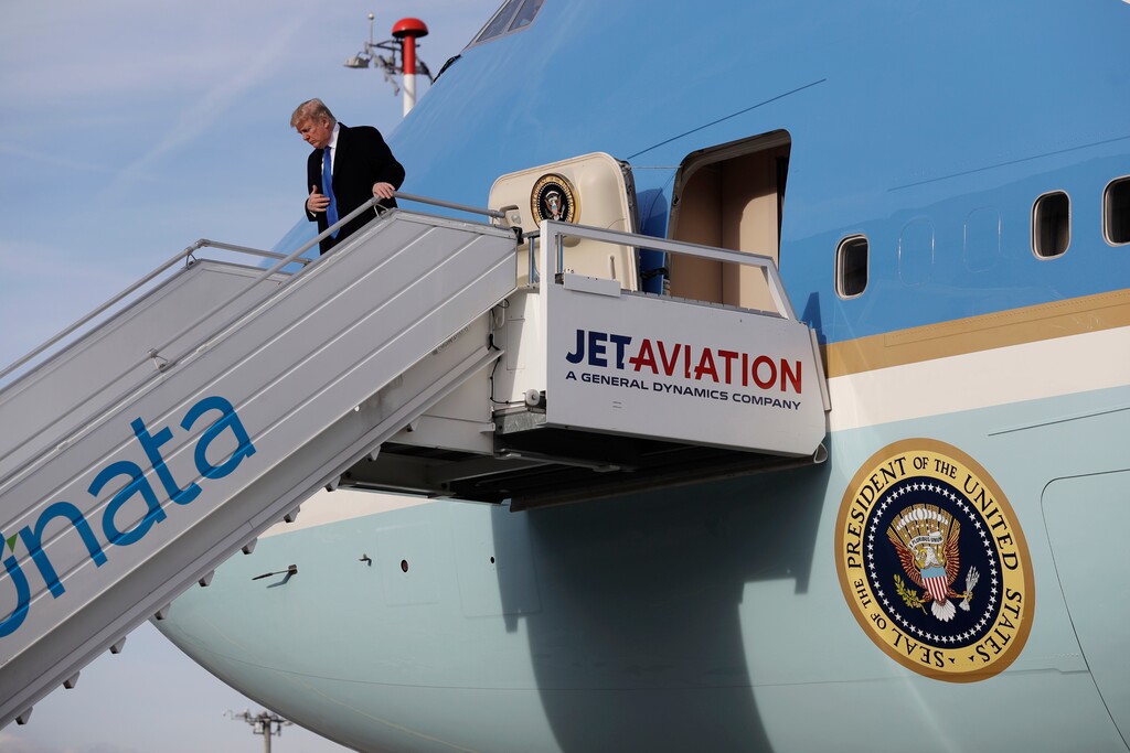 (Evan Vucci | The Associated Press) U.S. President Donald Trump steps off Air Force One on arrival at Zurich International Airport for the Davos World Economic Forum, Thursday, Jan. 25, 2018, in Zurich, Switzerland.  Trump is ready to play salesman at the Davos economic summit in the Swiss Alps.