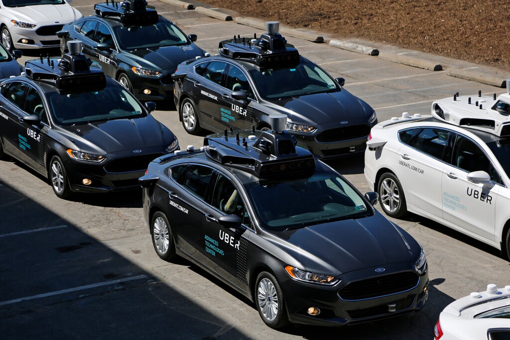 FILE- This Sept. 12, 2016, file photo, shows group of self driving Uber vehicles position themselves to take journalists on rides during a media preview at Uber's Advanced Technologies Center in Pittsburgh. Uber is settling a lawsuit filed by Google’s autonomous car unit alleging that the ride-hailing service ripped off self-driving car technology. Both sides in the case issued statements confirming the settlement Friday, Feb. 9, 2018, morning in the midst of a federal court trial in the case. (AP Photo/Gene J. Puskar, File)