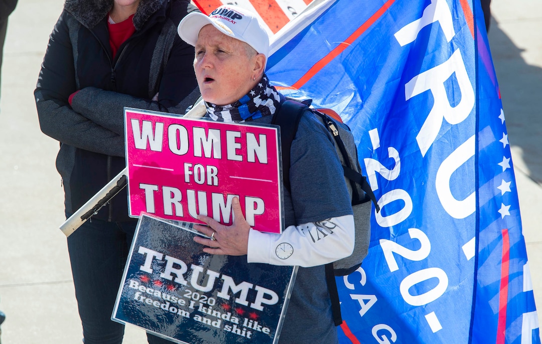 (Rick Egan | The Salt Lake Tribune). A small crowd of Trump protesters gather at the capitol with signs, flags and guns on Wednesday, Jan. 6, 2021.