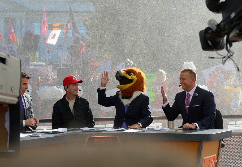 (Leah Hogsten | Tribune file photo) ESPN's "College GameDay" cast including Rece Davis, former Jazz star John Stockton and Kirk Herbstreit laugh as Lee Corso, second from right, places the head of Swoop, Utah's mascot, on his head, predicting the Utes will win the game vs. California. ESPN reportedly is considering another trip to Utah next weekend.
