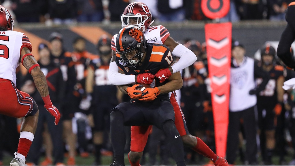 Oregon State wide receiver Isaiah Hodgins (17) is brought down by Utah defensive back Josh Nurse (14) during the second half of an NCAA college football game in Corvallis, Ore., Saturday, Oct. 12, 2019. Utah won 52-7. (AP Photo/Amanda Loman)