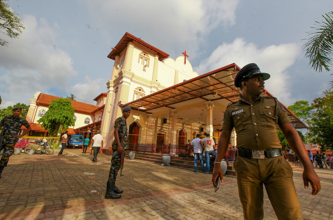 Sri Lankan army soldiers secure the area around St. Sebastian's Church damaged in blast in Negombo, north of Colombo, Sri Lanka, Sunday, April 21, 2019.  More than hundred were killed and hundreds more hospitalized with injuries from eight blasts that rocked churches and hotels in and just outside of Sri Lanka's capital on Easter Sunday, officials said, the worst violence to hit the South Asian country since its civil war ended a decade ago. (AP Photo/Chamila Karunarathne)