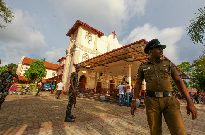 Sri Lankan army soldiers secure the area around St. Sebastian's Church damaged in blast in Negombo, north of Colombo, Sri Lanka, Sunday, April 21, 2019.  More than hundred were killed and hundreds more hospitalized with injuries from eight blasts that rocked churches and hotels in and just outside of Sri Lanka's capital on Easter Sunday, officials said, the worst violence to hit the South Asian country since its civil war ended a decade ago. (AP Photo/Chamila Karunarathne)