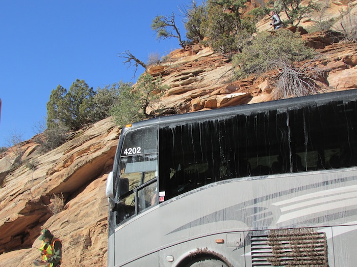 (Tom Wharton | The Salt Lake Tribune) One of the few National Park Service employees to be seen at Zion on Sunday was a worker who stops traffic so big busses can get through the narrow tunnel safely. Park services have been reduced because of a federal government shutdown that went into effect at midnight Friday after the Senate was unable to pass a new spending bill.