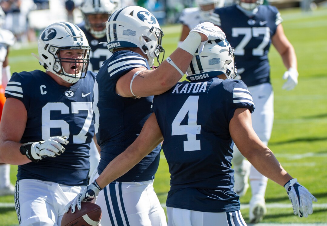 (Rick Egan  |  The Salt Lake Tribune)    Team mates congratulate Brigham Young running back Lopini Katoa (4) after scoring a Cougar touchdown, in football action between the Brigham Young Cougars and the UTSA Roadrunners, at Lavell Edwards stadium, Saturday, Oct. 10, 2020.