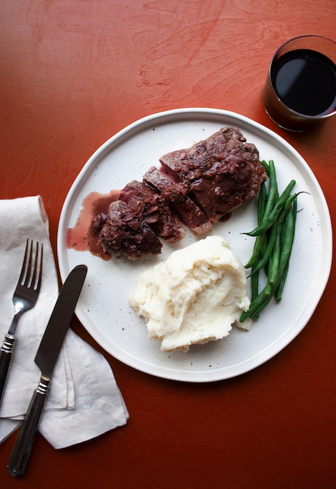 (Laura Agra via AP) This December 2016 photo shows a strip steak Diane. This dish is from a recipe by Katie Workman.