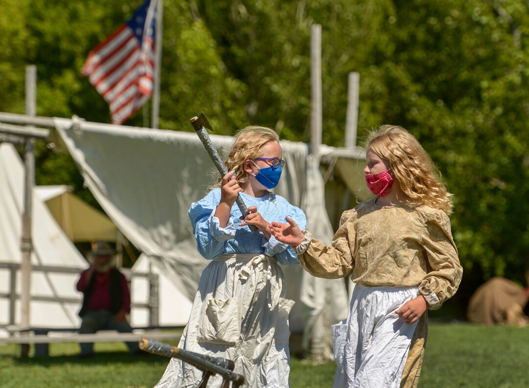 (Leah Hogsten  |  The Salt Lake Tribune) Savanna Mason and her twin sister Madyson, 10, learn how to throw a hatchet during Pioneer Day festivities at the American West Heritage Center in Wellsville, July 24, 2020.