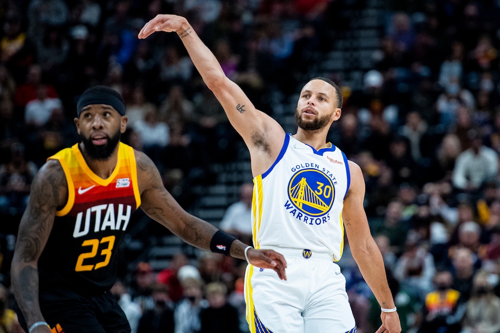 (Isaac Hale | AP) Golden State Warriors guard Stephen Curry (30) holds his follow-through on his shot while guarded by Utah Jazz forward Royce O'Neale (23) in the first half during an NBA basketball game Saturday, Jan. 1, 2022, in Salt Lake City.