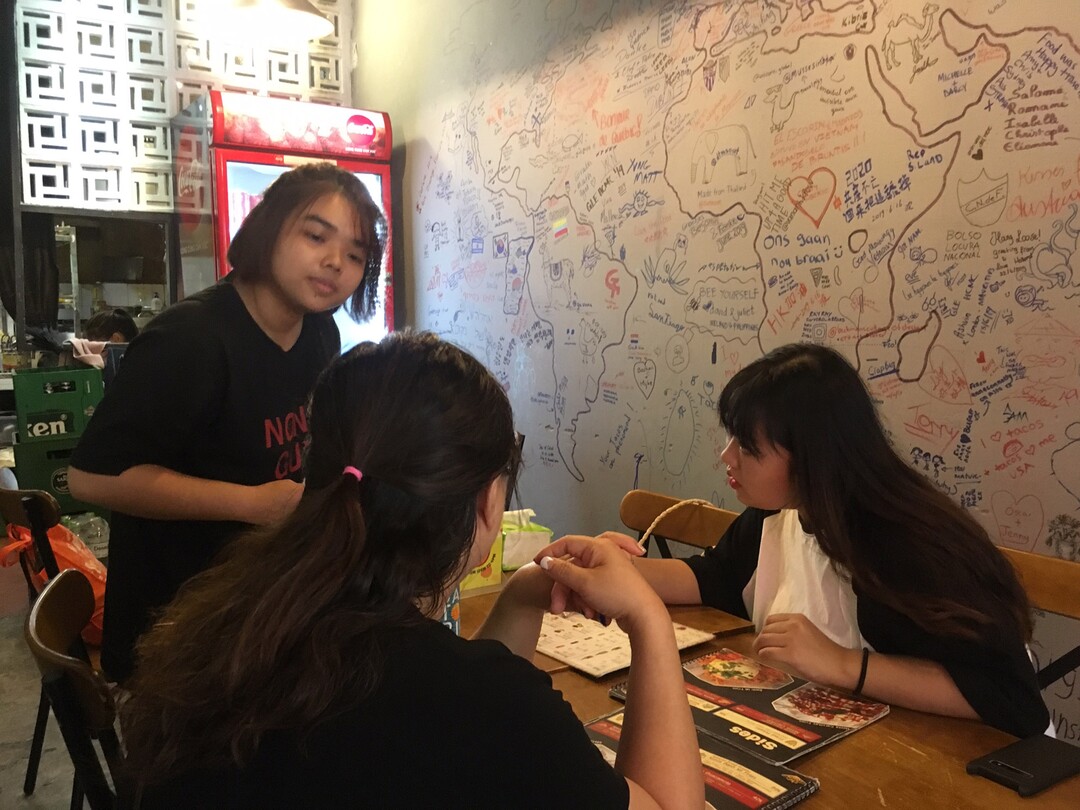 (Matilyn Mortensen | Special to The Tribune) Isuel Bae, at right, orders a rice bowl at Nonla Guys   restaurant in Ho Chi Mihn City. Bae, who had traveled from Korea to Vietnam with her mother, was intrigued to learn that three men from Korea owned the Asian-Mexican fusion restaurant, inspired by Copbop in Utah.