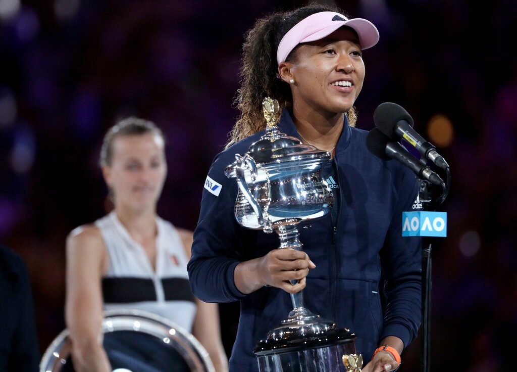 Japan's Naomi Osaka holds her trophy after defeating Petra Kvitova, left, of the Czech Republic during the women's singles final at the Australian Open tennis championships in Melbourne, Australia, Saturday, Jan. 26, 2019. (AP Photo/Mark Schiefelbein)