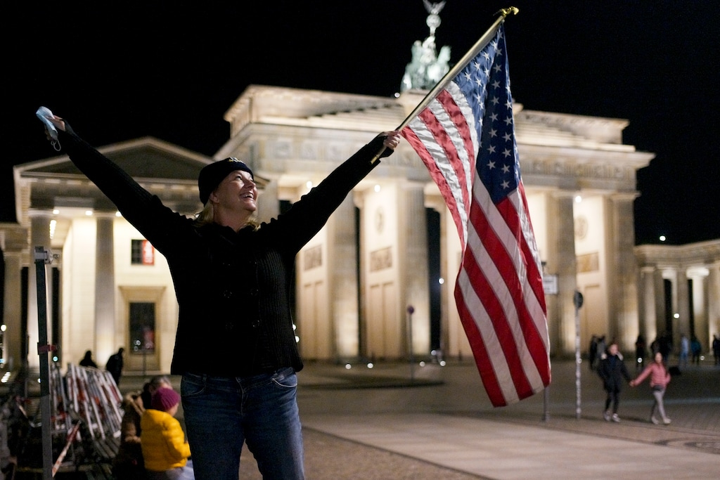 Marianne Hoenow from Connecticut celebrates the victory of President-elect Joe Biden and Vice President-elect Kamala Harris in front of the Brandenbug Gate next to the United States embassy in Berlin, Germany, Saturday, Nov. 7, 2020. (Photo/Markus Schreiber)