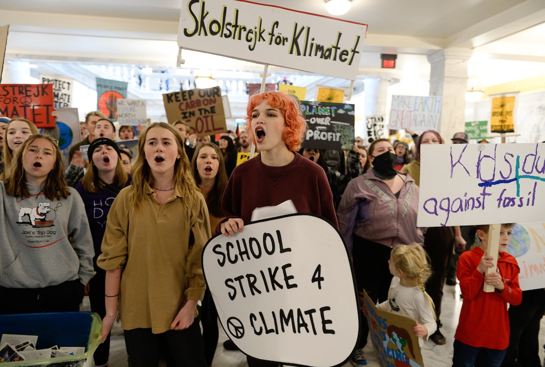 (Francisco Kjolseth  |  The Salt Lake Tribune)  Aurora Laird, center, joins Nina Serafin, center left, along with numerous other students as they chant "this is what democracy looks like!" as they gather outside the office of Gov. Gary Herbert on the Utah Capitol on Friday, Dec. 6, 2019, in an effort to deliver over 4,000 written cards with the importance of protecting Utah lands and clean air solutions. Fridays For Future, Utah Youth Environmental Solutions, and partners strike in opposition to Utah’s final oil and gas lease sale of 2019 that will auction off public lands and further fossil fuel development.