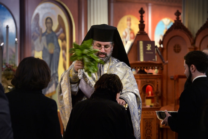 (Scott Sommerdorf | The Salt Lake Tribune)
The Very Rev. Archimandrite George Nikas blesses congregants with holy water from a bouquet of basil as he conducts the Epiphany service (also called Theophany in Orthodox), as holy water is blessed, at Holy Trinity Cathedral, Saturday, January 6, 2018.