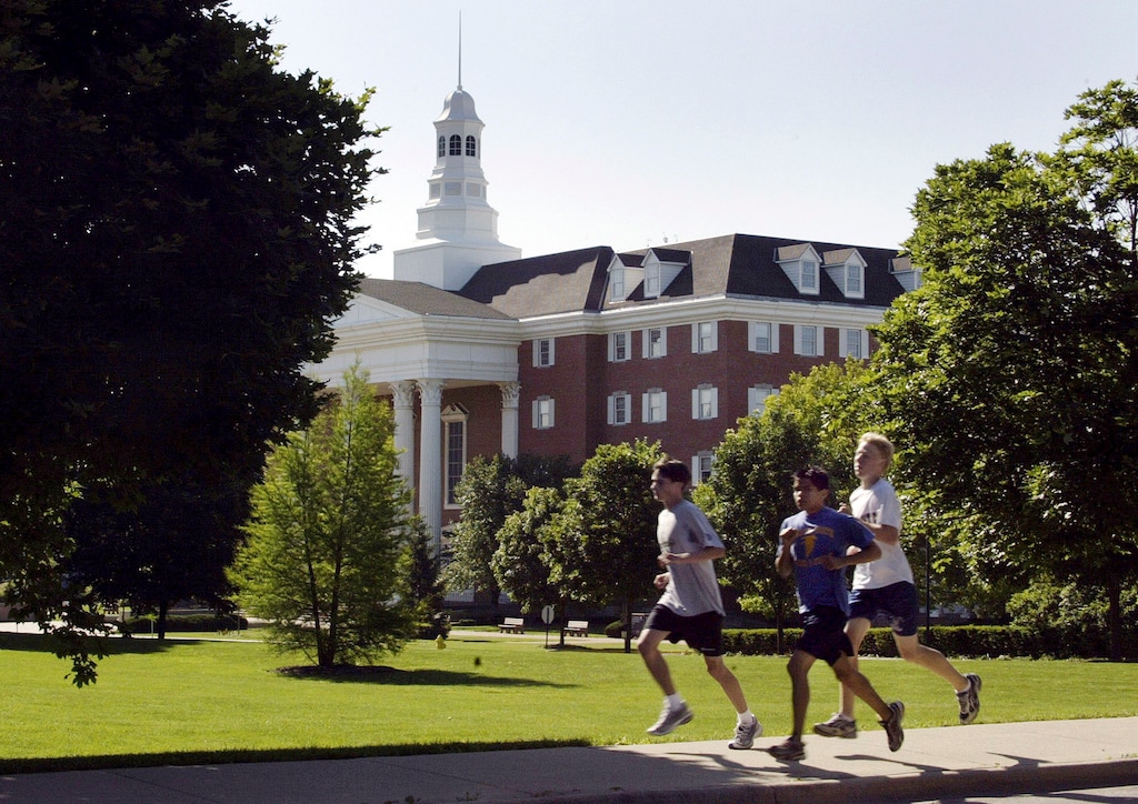 FILE - In this June 20, 2003 file photo, joggers run through the campus of Wheaton College in Wheaton, Ill. More than 1,000 miles away there's another Wheaton College in Norton, Mass. Though people often confuse the schools, the two aren't related. (AP Photo/Brian Kersey, File)