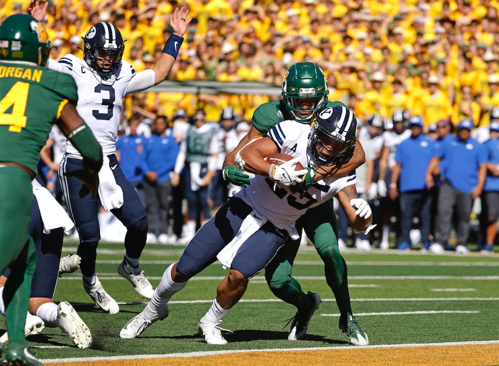 BYU quarterback Jaren Hall (3) celebrates as teammate and running back Tyler Allgeier (25) crosses the goal line to score a touchdown as Baylor safety JT Woods (22) defends during the first half of an NCAA college football game, Saturday, Oct. 16, 2021, in Waco, Texas. (AP Photo/Ron Jenkins)