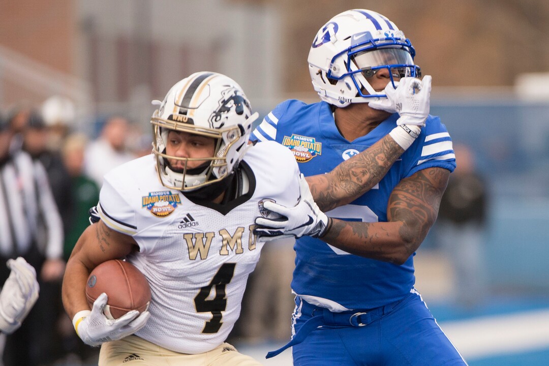 (Jeremy Harmon  |  The Salt Lake Tribune) Western Michigan Broncos quarterback Chris Riddle (4) is tackled by Brigham Young Cougars defensive back Dayan Ghanwoloku (5) as BYU faces the Western Michigan Broncos in the Famous Idaho Potato Bowl in Boise, Idaho, on Friday, Dec. 21, 2018.