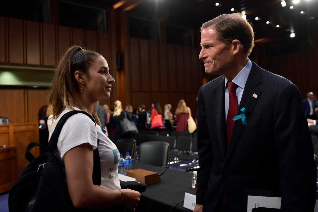 (Susan Walsh | AP) Olympic gold medalist Aly Raisman, left, talks with Sen. Richard Blumenthal, D-Conn., right, following a Senate Commerce subcommittee hearing on "Strengthening and Empowering U.S. Amateur Athletes," on Capitol Hill in Washington, Tuesday, July 24, 2018.