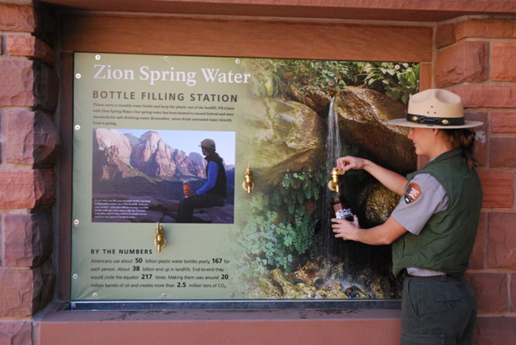 (John Marciano  |  Zion National Park)  A Zion National Park staffer fills a bottle at one of four water filling stations installed as part of an effort to rid the park of disposable plastic bottles. On Wednesday, the National Park Service rescinded the 2011 policy that allowed Zion and several other Utah parks to ban sales of bottled water.