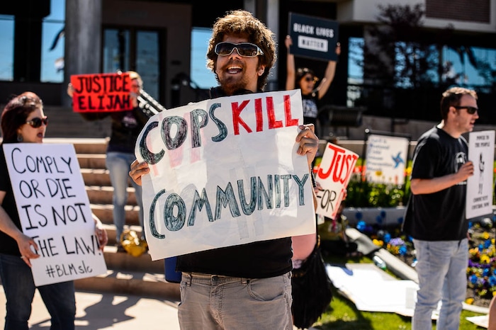 (Trent Nelson | The Salt Lake Tribune)
Utah Against Police Brutality holds a rally in front of West Valley City Hall, Saturday April 21, 2018. Elijah Smith was killed by West Valley Police on April 8 after he ran from them into a home. They shot him in the home's garage, while one hand was in the air and the other, activists say, appeared to be coming up, too. After body camera footage was released, the group began to call for the officer's firing.