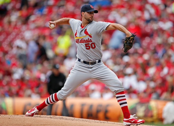 St. Louis Cardinals starting pitcher Adam Wainwright (50) throws against the Cincinnati Reds during the first inning of a baseball game, Sunday, Aug. 6, 2017, in Cincinnati. (AP Photo/Gary Landers)