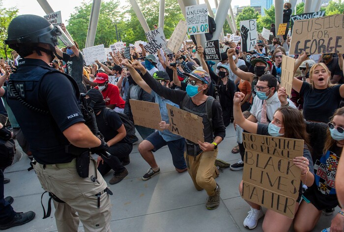 (Rick Egan  |  The Salt Lake Tribune)     Protesters urge the police to kneel with them at the Public Safety Building in Salt Lake City, Monday, June 1, 2020.