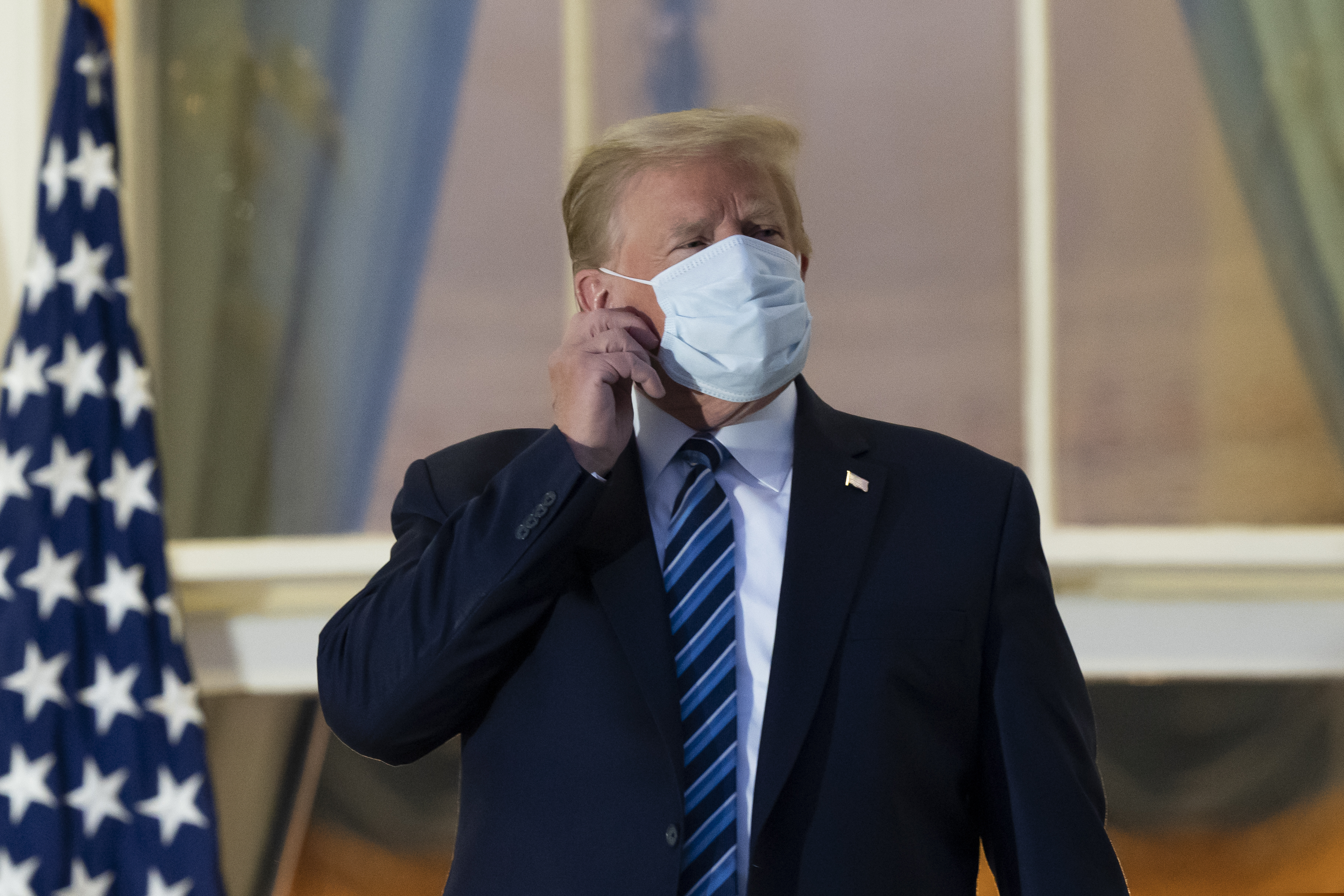 (Alex Brandon | AP file photo)
In this Oct. 5, 2020, photo, President Donald Trump removes his mask as he stands on the Blue Room Balcony upon returning to the White House in Washington, after leaving Walter Reed National Military Medical Center, in Bethesda, Md. Trump announced he tested positive for COVID-19 on Oct. 2.