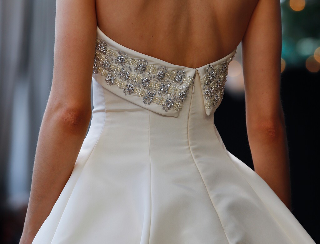 (Bebeto Matthews | The Associated Press) In this April 13, 2018 file photo, bridal fashion from the Amsale collection is modeled during Bridal Fashion Week in New York.  Buying a wedding dress online is a much different experience than doing so in a store. Shopping online can help brides make more clear-headed and less emotion-driven purchases. But it also requires brides to be their own consultants, who are familiar with fabrics, cuts and more.