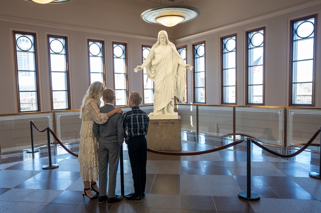(Rick Egan | The Salt Lake Tribune) A family observes the Christus statue at the Conference Center in downtown Salt Lake City. Latter-day Saints view Jesus as the perfect role model, but their grapples with perfectionism are complicated.