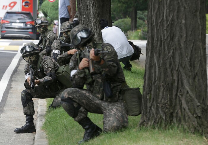 FILE- In this Aug. 24, 2016, file photo, South Korean army soldiers conduct an anti-terror drill as part of Ulchi Freedom Guardian exercise, at the National Assembly in Seoul, South Korea. America’s annual joint military exercises with South Korea always frustrate North Korea. The war games set to begin Monday, Aug. 21, 2017 may hold more potential to provoke than ever, given President Donald Trump’s “fire and fury” threats and Pyongyang’s as-yet-unpursued plan to launch missiles close to Guam. (AP Photo/Ahn Young-joon, File)