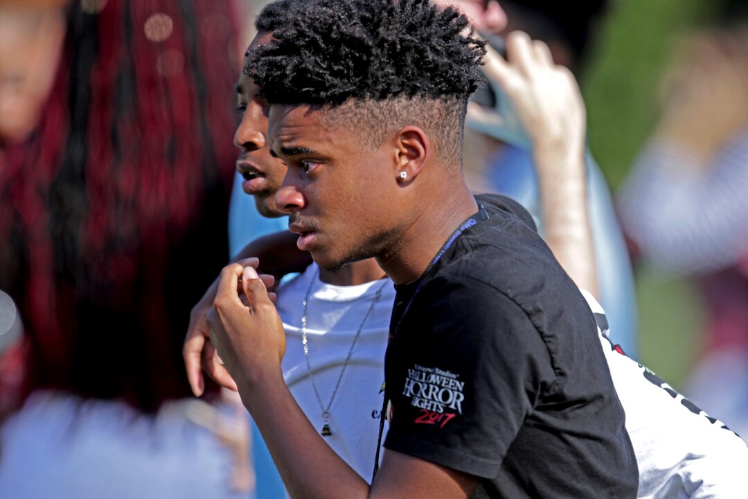 Students released from a lockdown walk away following a shooting at Marjory Stoneman Douglas High School in Parkland, Fla., on Wednesday, Feb. 14, 2018. (John McCall/South Florida Sun-Sentinel via AP)