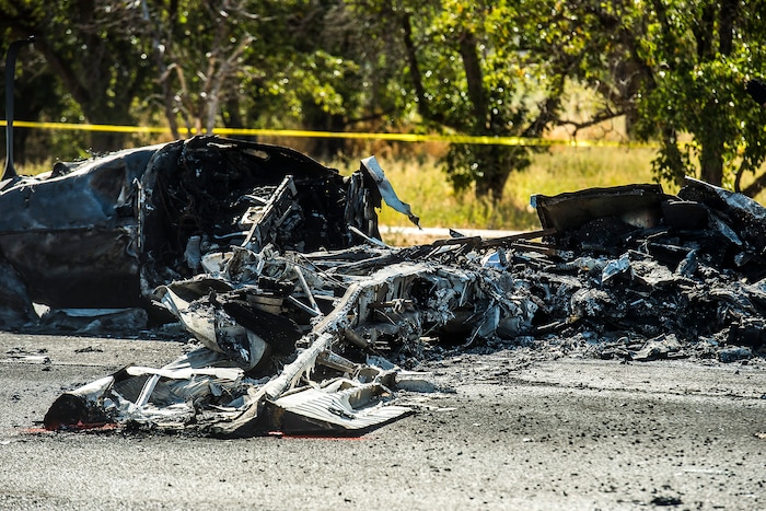(Chris Detrick  |  The Salt Lake Tribune)  The scene of a plane crash at 1900 West and 4500  South in Roy Tuesday, September 12, 2017. The pilot of a single-engine airplane survived a fiery crash on a street in Roy Tuesday afternoon, authorities said. Roy police Sgt. Matthew Gwynn said the pilot was transported to a hospital “out of precaution,” as was the driver of a car that the plane hit.