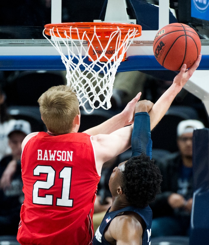 (Rick Egan  |  The Salt Lake Tribune)  Utah Utes forward Tyler Rawson (21) goes to the basket as Utah State Aggies guard Brock Miller (22) defends, in Beehive Classic basketball action at the Vivint SmartHome Arena, Saturday, December 9, 2017.