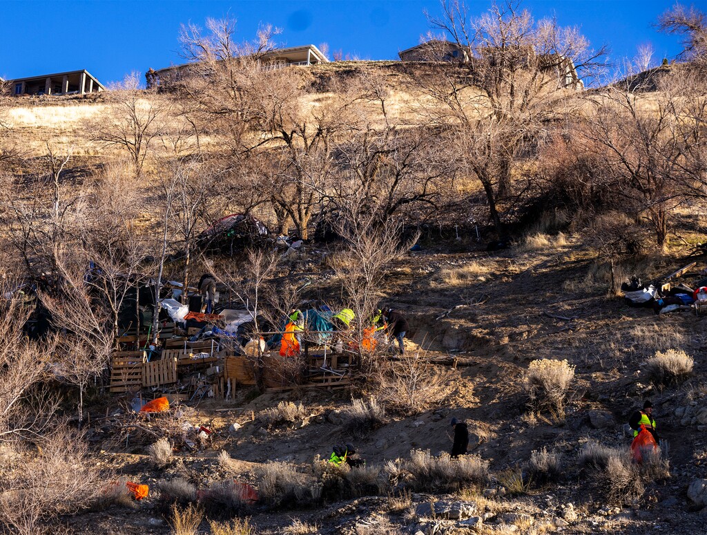 (Rick Egan | The Salt Lake Tribune)  Members of the Salt Lake County Health Department and Advantage Services treat down a camp on the mountain above Victory road, on Thursday, December 14, 2023.