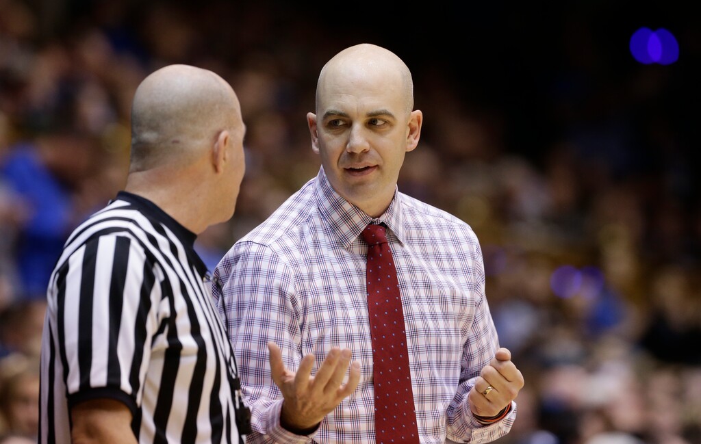 (AP Photo/Gerry Broome) South Dakota head coach Craig Smith speaks with an official during the first half of an NCAA college basketball game against Duke in Durham, N.C., Saturday, Dec. 2, 2017. (AP Photo/Gerry Broome)