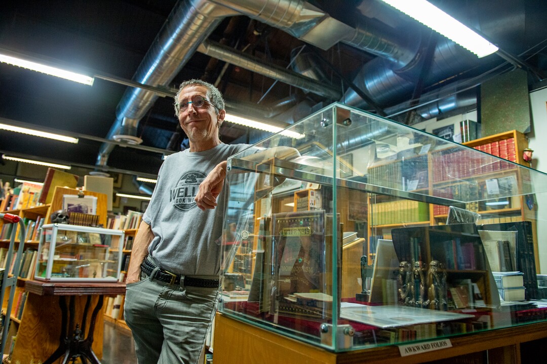 (Leah Hogsten  |  The Salt Lake Tribune)  Tony Weller talks with a customer in the rare book section of Weller Book Works, August 7, 2019. Weller Book Works — formerly Zion Bookstore and Sam Weller's Books — is celebrating its 90th year.