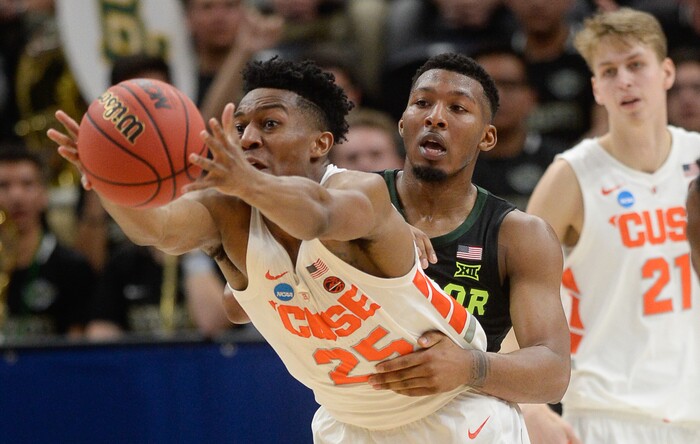 (Francisco Kjolseth  |  The Salt Lake Tribune)  Syracuse Orange guard Tyus Battle (25) is held back by Baylor Bears guard King McClure (3) as Syracuse faces Baylor in their first round men's NCAA March Madness tournament game at Vivint Smart Home Arena in Salt Lake City on Thursday, March 21, 2019.