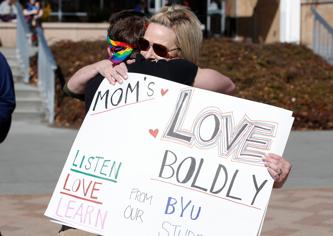(George Frey | Special to Tribune) Kyle Brodrick, left, a sophomore at BYU, is hugged by his mother Joni who flew in from Virginia to support her son and other BYU students in protest of BYU's rollback of a newly announced policy change on LGBTQ students at the campus of Brigham Young University on March 5, 2020 in Provo.