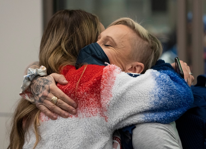 (Rick Egan | The Salt Lake Tribune) Stephanie Love, left, the mother of bobsledder and Herriman local Kaysha Love, hugs bobsled athlete Kaillie Humphries as she and other Team USA Olympians arrive at the Salt Lake City International Airport on Monday, Feb. 21, 2022.