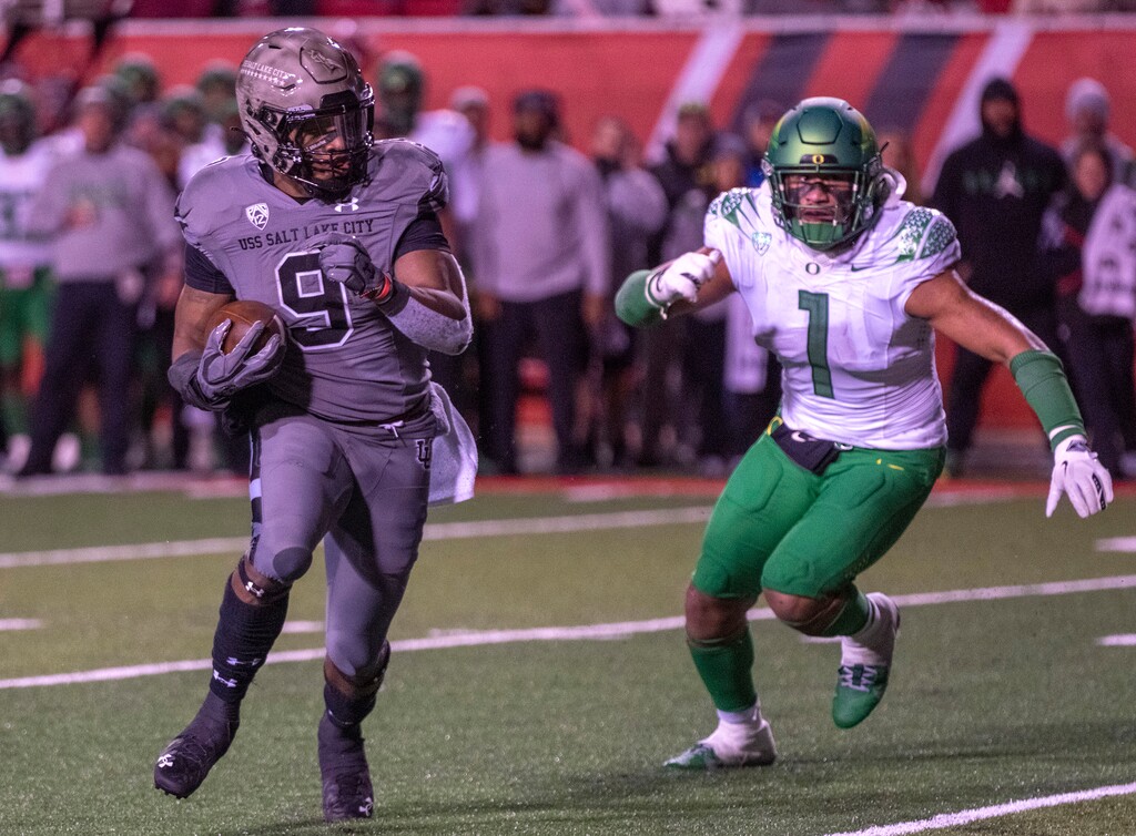 (Rick Egan | The Salt Lake Tribune) Utah Utes running back Tavion Thomas (9) is chases by Oregon Ducks linebacker Noah Sewell (1) as he runs for a touchdown, in PAC-12 action between the Utah Utes and the Oregon Ducks, at Rice-Eccles Stadium in Salt Lake City, on Saturday, Nov. 20, 2021.