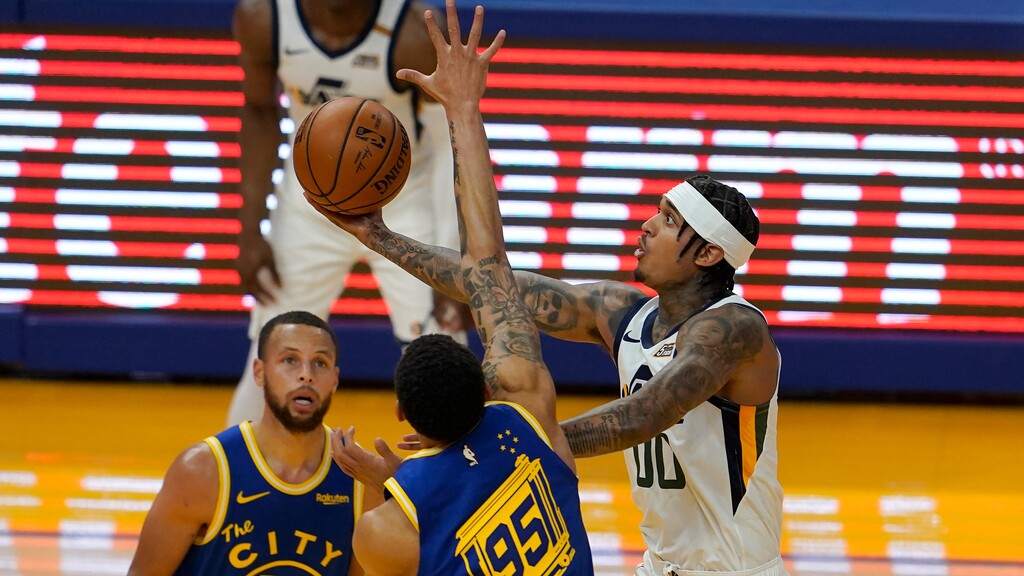 Utah Jazz guard Jordan Clarkson, right, shoots against Golden State Warriors guard Stephen Curry (30) and forward Juan Toscano-Anderson (95) during the first half of an NBA basketball game in San Francisco, Monday, May 10, 2021. (AP Photo/Jeff Chiu)