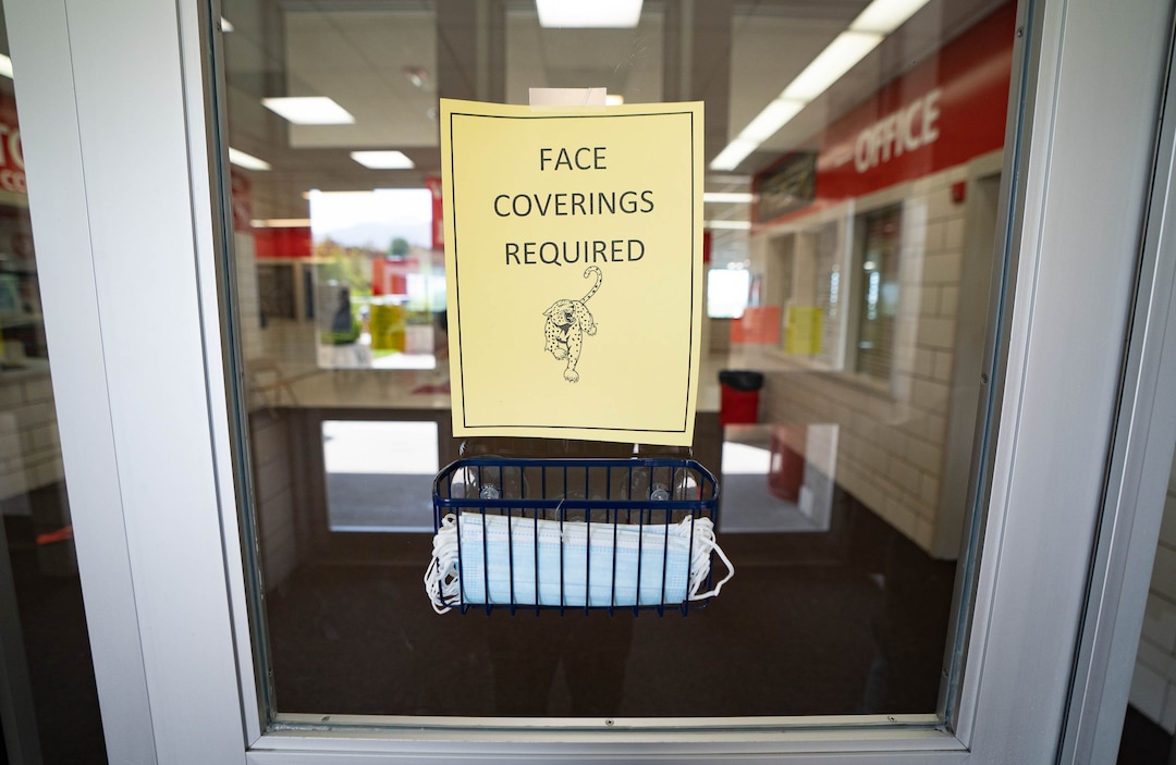 (Francisco Kjolseth | The Salt Lake Tribune) A sign reading face coverings required along with masks are posted at the doors as East High School welcomes students back for the first day of school on Tuesday, Aug. 24, 2021.