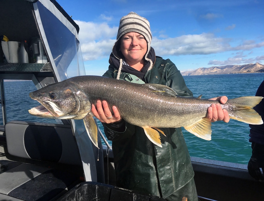 (Photo courtesy of Utah Division of Wildlife Resources) Utah DWR fisheries technician Emily Wright displays a massive lake trout caught and released in Bear Lake during a gillnetting survey in 2019.