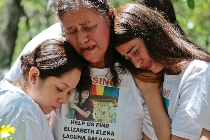 Mayra Vargas, left, wife of Julio Cesar Laguna-Salgado, along with Libertad Edith Salgado-Figueroa, center, and Ruth Yolanda Laguna-Salgado, mourn together, Friday, June 15, 2018, in Hobble Creek Canyon near Provo, Utah, at the site where Vargas' sister-in-law Elizabeth Elena Laguna-Salgado was found. The remains of the 26-year-old Mexican woman were discovered by a passer-by looking for a camping spot last month. She had been missing since April 16, 2015, when she was last seen walking home from her English language class. (Evan Cobb/The Daily Herald via AP)