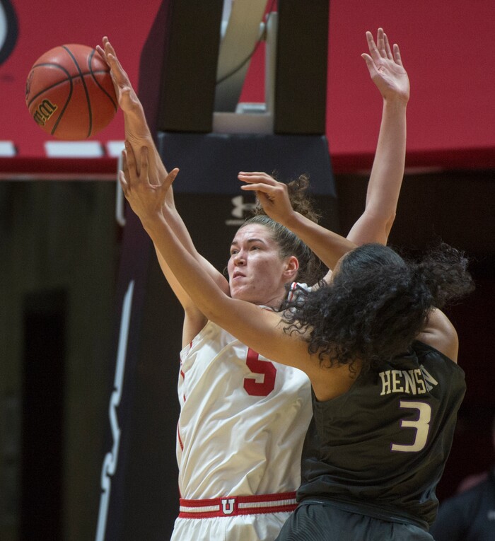 (Rick Egan  |  The Salt Lake Tribune)       Utah Utes center Megan Huff (5) blocks a shot by Washington Huskies forward Mai-Loni Henson (3), in PAC-12 women's basketball action at the Jon M. Huntsman Center, Sunday, Feb. 18, 2018.