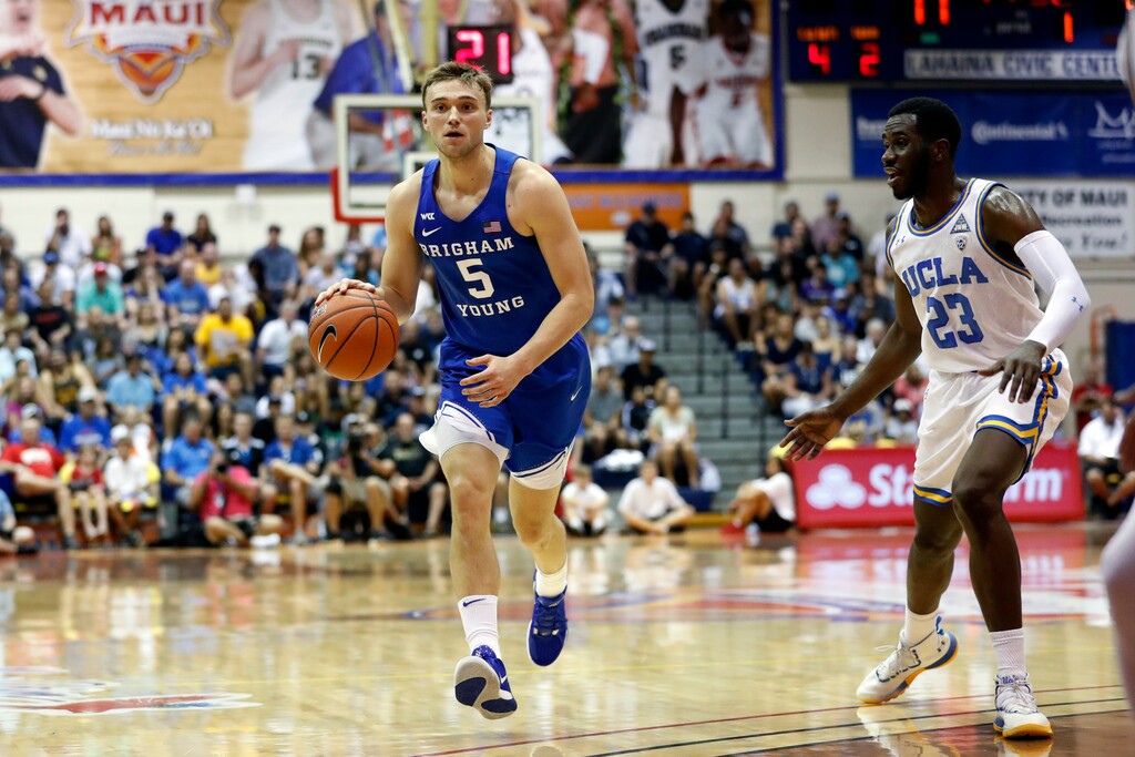 BYU guard Jake Toolson (5) dribbles past UCLA guard Prince Ali (23) during the first half of an NCAA college basketball game, Monday, Nov. 25, 2019, in Lahaina, Hawaii. (AP Photo/Marco Garcia)
