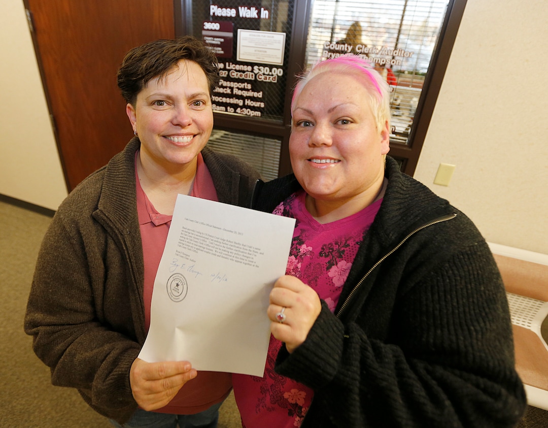  Raylynn Marvel left, and Patsy Carter right, from Orem, Utah, leave the offices of the Utah County Clerk and Auditor office and hold a rejection letter for a marriage license on July 20, 2013 in Provo, Utah. A Federal Judge on Friday struck down Utah's ban on same sex marriage saying the law violates the U.S. Constitution.  (Photo by George Frey  |  Special to the Tribune)