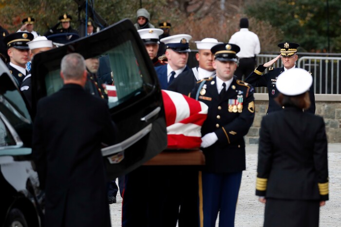 The flag-draped casket of former President George H.W. Bush is carried by a joint services military honor guard into a State Funeral at the National Cathedral, Wednesday, Dec. 5, 2018, in Washington. (AP Photo/Alex Brandon, Pool)