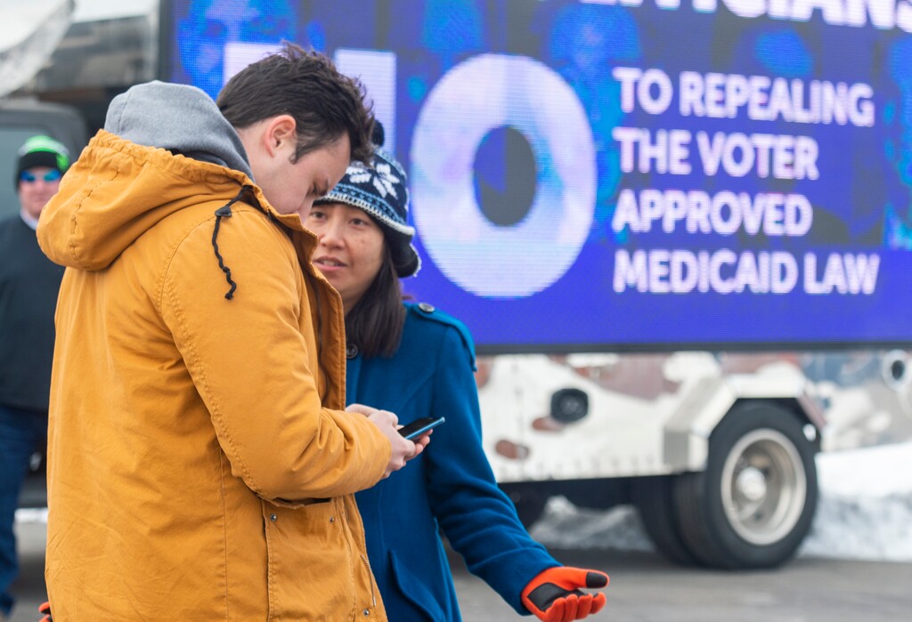 (Rick Egan  |  The Salt Lake Tribune)  Keaton Hill talks to Dawn Le as they plan to canvas a neighborhood in Taylorsville with other supporters of the fuller Medicaid expansion, urging residents to call their senator, Saturday, Feb. 9, 2019. 