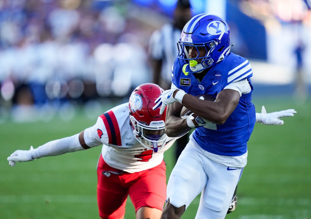 (Francisco Kjolseth | The Salt Lake Tribune) BYU Cougars wide receiver Legend Glasker (1) is pressured by Utah Tech Trailblazers defensive back Shaun Niu Jr. (4) during the first half of an NCAA college football game against Utah Tech, Saturday, Sept. 5, 2026, at LaVell Edwards Stadium in Provo.